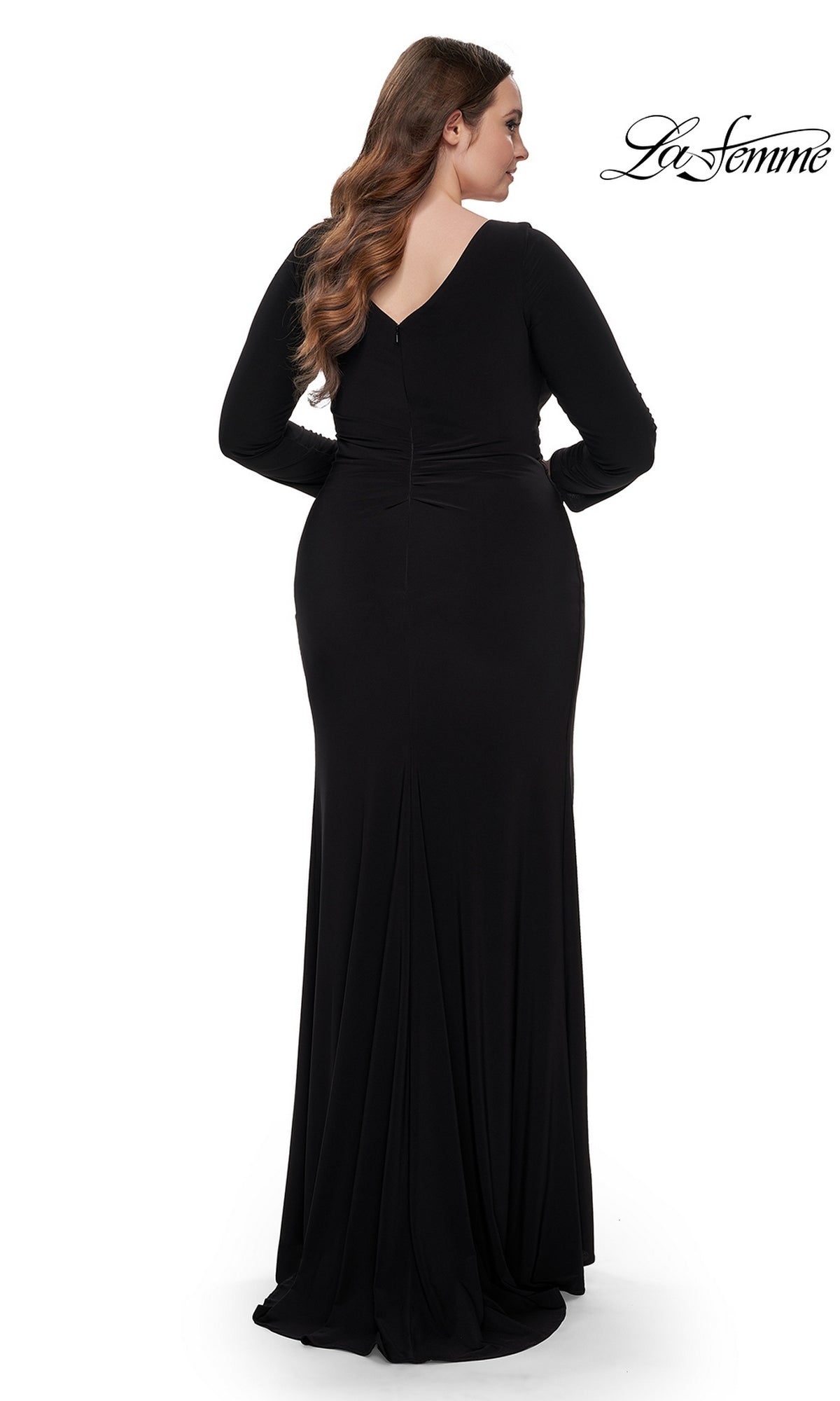 A woman models the La Femme Plus-Size Black Jersey Formal Dress 32191, a floor-length long sleeve gown, shown from the back against a white background with the La Femme logo in the top right corner.